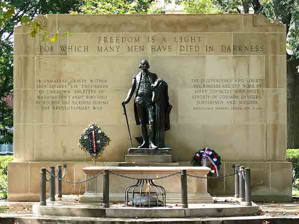 The Tomb of the Unknown Revolutionary War Soldier in Washington Square, Philadelphia, PA, USA, featuring a replica of Jean-Antoine Houdon's famous bronze sculpture of George Washington.